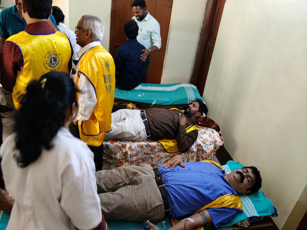 CONDUCTING BLOOD DONATION CAMP.